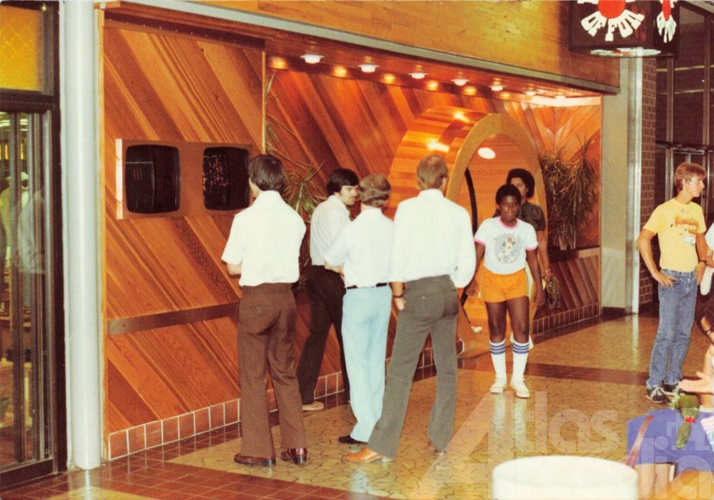 Mall shoppers outside Barrel of Fun arcade in South Dekalb mall, 1982