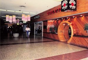 Wooden storefront with barrel-shaped entrance and sign for Barrel of Fun in South Dekalb Mall in 1987