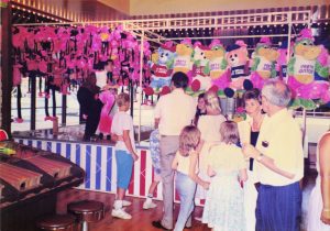 Customers surround the Goblet Toss and Ring Toss games at Barrel of Fun #13, Commander Ragtime's