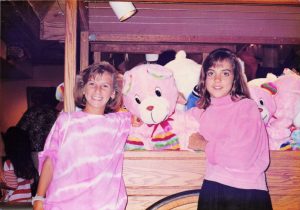 Two young ladies prize winners pose with a large plush bear at Barrel of Fun #13, Commander Ragtime's